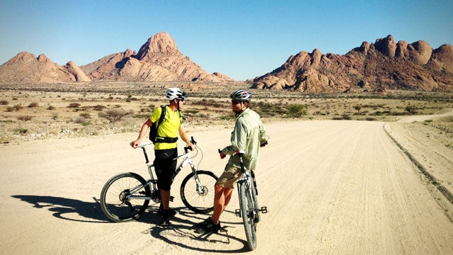 Riding beneath the Spitzkoppe, Namibia's most iconic peak.