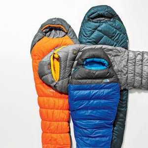 closeup of four sleeping bags on white background