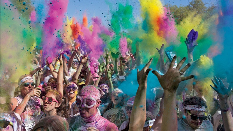 Runners toss up packets of colored dye after completing The Color Run 5K in Seattle, Wash. May 13, 2012.