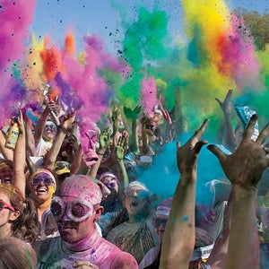 Runners toss up packets of colored dye after completing The Color Run 5K in Seattle, Wash. May 13, 2012.
