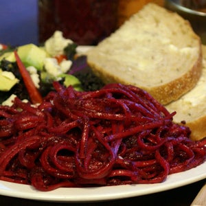 Beet Pesto; Linguine with beet pesto; a side kale salad with Gorgonzola cheese; avocados and red bell pepper; and some sliced artisan bread with butter.