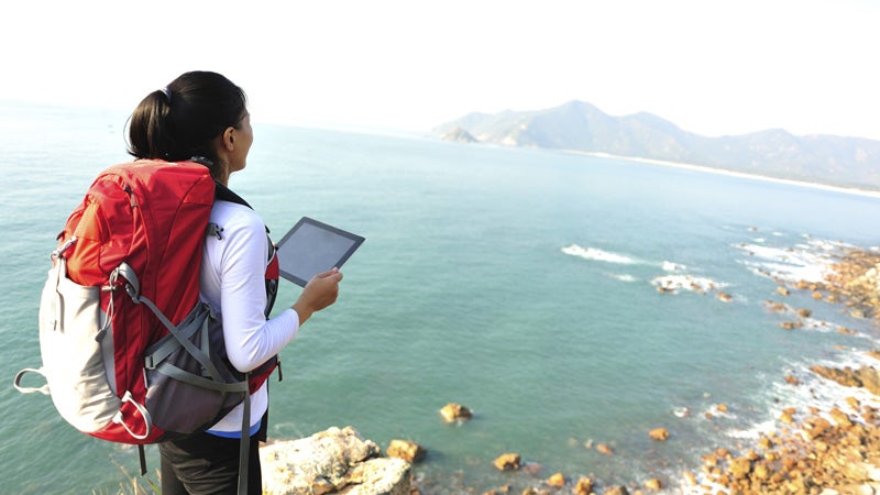 hiking woman use tablet pc seaside