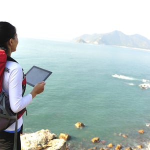 hiking woman use tablet pc seaside
