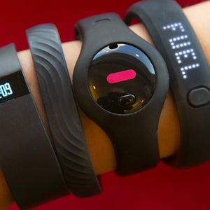 Four fitness trackers are shown in this photograph, in New York,  Monday, Dec. 16, 2013. They are, from left, Fitbit Force, Jawbone Up, Fitbug Orb, and the Nike FuelBand SE.  For aspiring health nuts and to inspire couch potatoes to get active, the latest crop of fitness gadgets will record much more than how many steps you took on any given day. From sleep patterns to calorie intake, mood and progress toward exercise goals, few aspects of life are left un-tracked for those in search for a more quantified self. (AP Photo/Richard Drew)