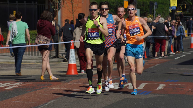 American Ryan Vail leads a pack of runners up Westferry Road at the 2014 London Marathon.