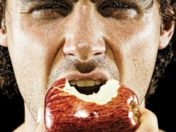 man biting into apple