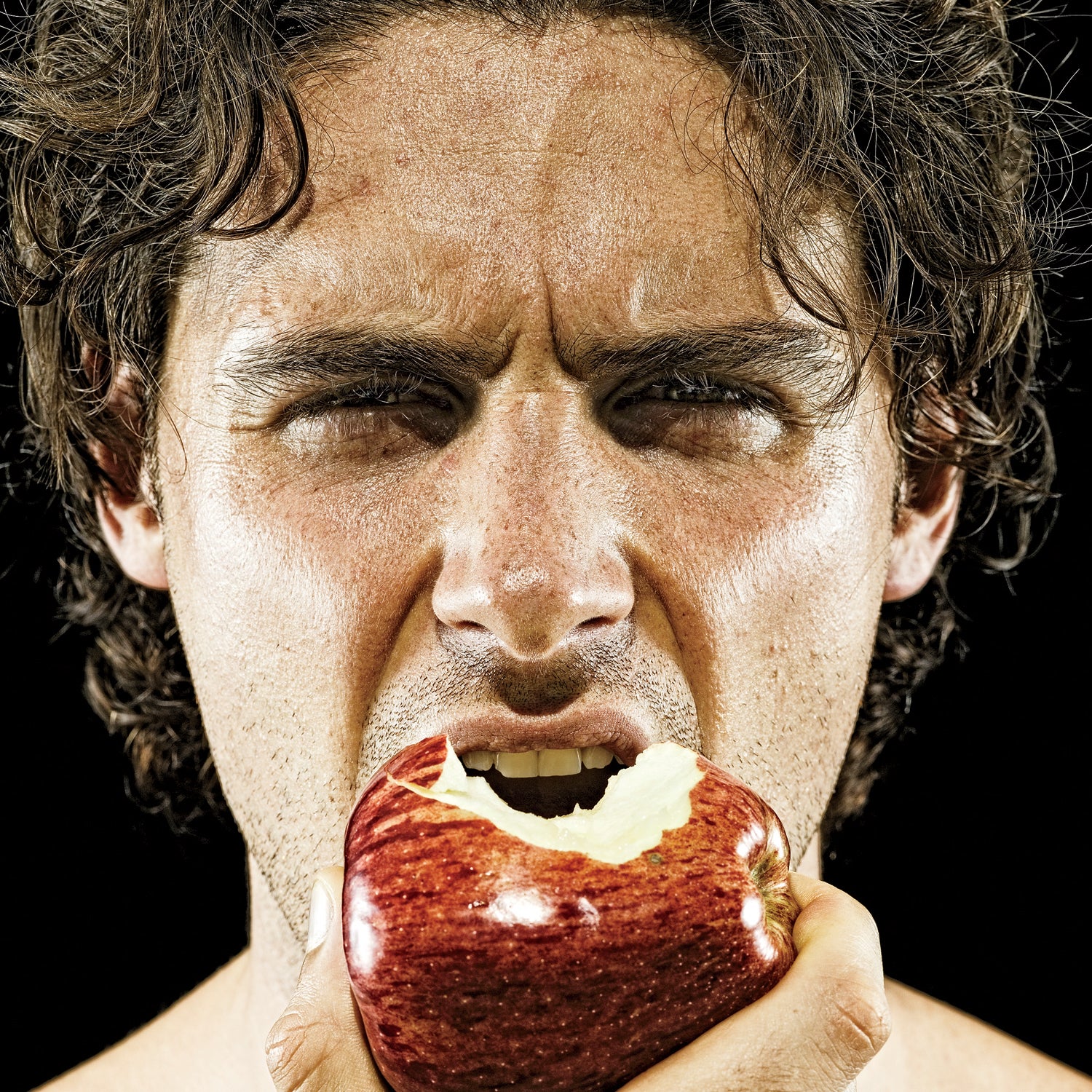 man biting into apple