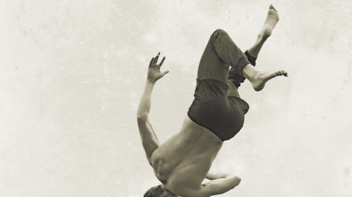 bare chest barefoot body part Brandon Clement brunette Caucasian appearance cuff falling FASHION full length (composition) human back Kenzo layered clothing man Mattias Karlsson mid-air motion pants profile rear view rolled-up shirtless shorts sky Tomo Jidai upside down young adult