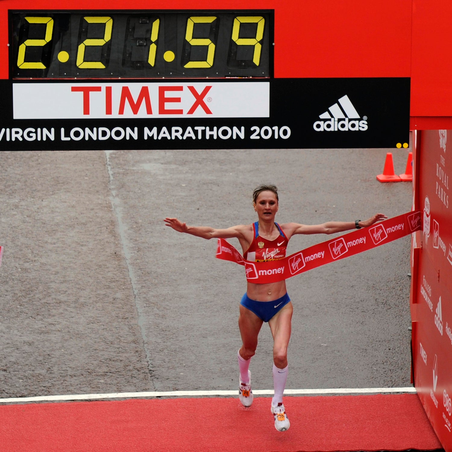 Russia's Liliya Shobukhova crosses the finish line to win the London Marathon, in London, Sunday April 25, 2010. (AP Photo/Tom Hevezi)