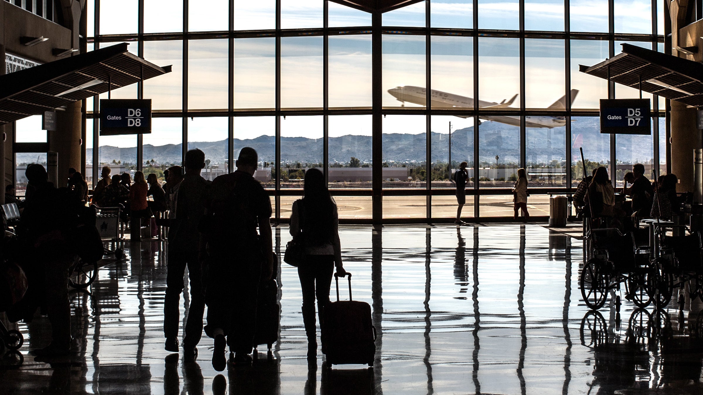Phoenix Sky Harbor PHX airport. Terminal 4 Concourse D Phoenix people travelers air travel transportation sillouette passengers Southwest United Airlines gates boarding pass anxiety windows airliner