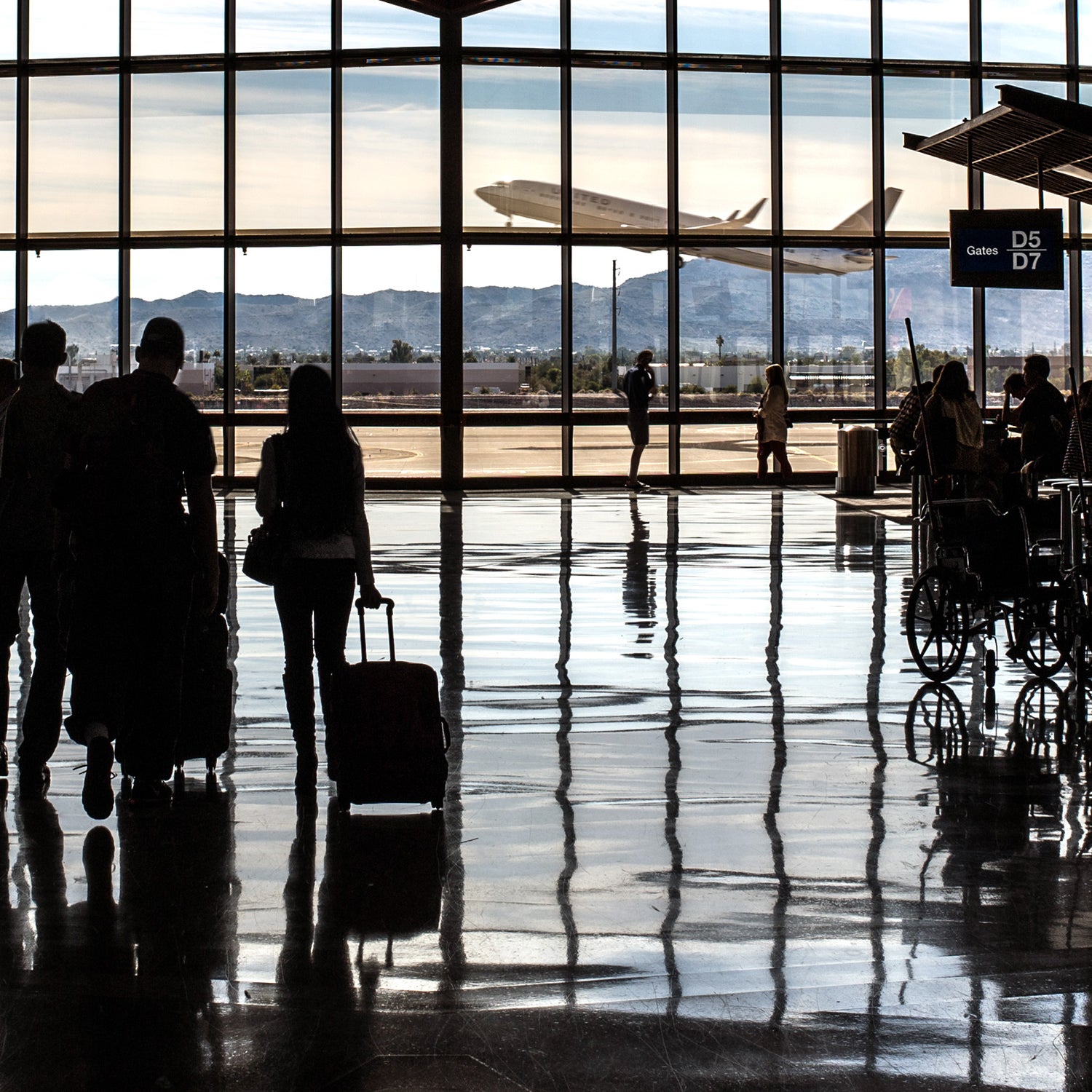 Phoenix Sky Harbor PHX airport. Terminal 4 Concourse D Phoenix people travelers air travel transportation sillouette passengers Southwest United Airlines gates boarding pass anxiety windows airliner