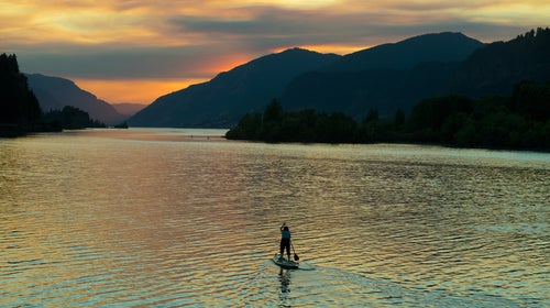 A brush fire lights up the sky over Hood River, Oregon, during an evening of SUP.