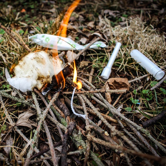 In inclement weather, starting a fire Boy-Scout-style can be a bit tricky. Thankfully, Stewart says tampons are among the best tinder on the planet. Begin by removing the cotton plug from its waterproof wrapper and plastic applicator. Then pull apart the tampon to expose the highly-flammable individual fibers—these will burst into flame with just a spark from a ferro rod or cigarette lighter.