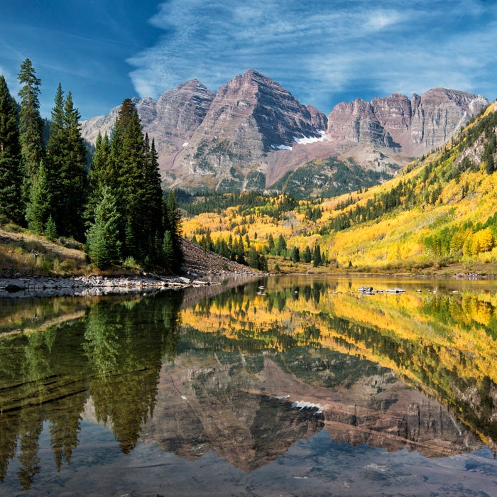 The Maroon Bells boast some of the most scenic hiking in the country, and many people complete the route safely every year—but it’s not to be taken for granted. The 12-mile round-trip hike to the summit of the South Ridge is fraught with loose rock fields, steep paths, gullies, and plenty of places to get lost. Oh yeah, and there’s the mercurial weather.
The trail is relatively easy until you get above 11,000 feet on its east slope. From there, the climb gets rougher the higher you get. The Maroon Bells got their deadly reputation after eight people died in five separate incidents, earning them the nickname “The Deadly Bells.” A U.S. Forest Service sign on the trail sums it up: “The beautiful Maroon Bells … have claimed many lives in the past few years. They are not extreme technical climbs, but they are unbelievably deceptive. The rock is down sloping, rotten, loose, and unstable. It kills without warning. The snowfields are treacherous, poorly consolidated, and no place for a novice climber. … Expert climbers who did not know the proper routes have died on these peaks.”