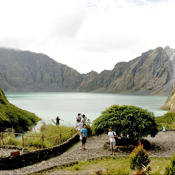 People come from all over the world to hike up to Mount Pinatubo’s crater lake. But after 400 years of dormancy, this volcano suddenly erupted in 1991, killing 800 people. It erupted again in 1992, that time claiming 72 victims.
The Pinatubo eruption was the second largest of the century, ejecting at least 15 million tons of sulfur dioxide gas, which lowered temperatures on a global scale, temporarily accelerated depletion of the ozone layer, and brought lahars (showers of volcanic debris) raining down.
If you ignore the volcano’s tendency to blow up suddenly, the hike itself is relatively easy and takes anywhere from 50 minutes to two hours. If you take a dip in the crater lake, beware of floating into the middle, where there are strong currents.