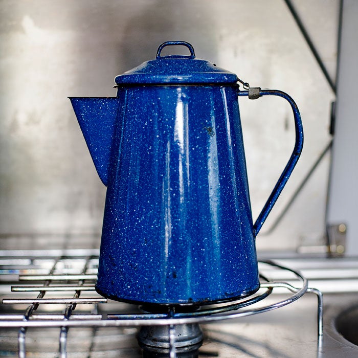 As a dad, I was nervous carrying three gallons of highly flammable propane in the stock under-van tank. Instead, I plumbed in a line and mini-regulator that allows the stove to be run on disposable propane canisters we store in the roof box.