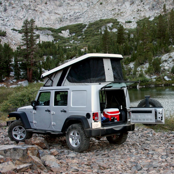 Ursa Minor gained fame with its E-camper Honda Element pop-up—a conversion that cost much less than other options on the market. When the car was discontinued, Ursa started making modern pop-tops for Jeep Wranglers (starting at $5,700). 

The flatbed-camper design minimizes noise, maximizes fuel economy, and adds only about six inches to the Jeep’s height. When fully opened, the space is large enough to accommodate a seven-foot mattress, interior LED lighting, and zippered screen windows. You’ll be comfortable, no matter the campsite. A fold-over version holds four people.