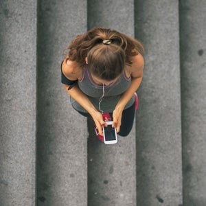 fitness fit sport exercise train athlete trainer training woman female outdoors urban city young mobile phone cell cellphone cellular music mp3 earphones headphones Directly Above copy space sportswear workout health healthcare wellness healthy slim thin wellbeing caucasian white