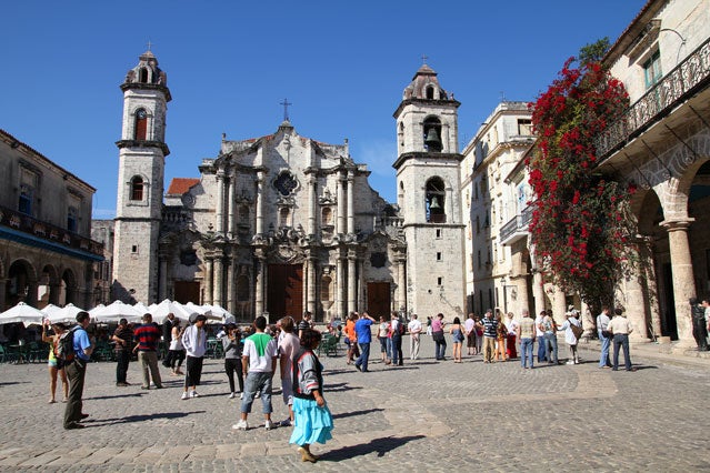 Tourists visit a cathedral in Havana.