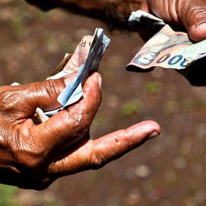 Indonesian money is passed from one person to another