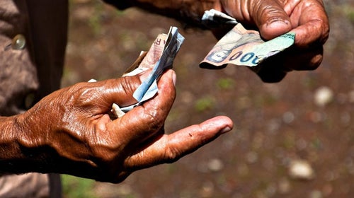 Indonesian money is passed from one person to another