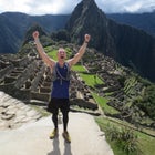 A runner celebrates at Machu Picchu.