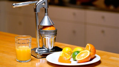 indoor nobody small group of objects juicer glass fruit oranges orange juice plate slices kitchen fresh food preparation selective focus copy space