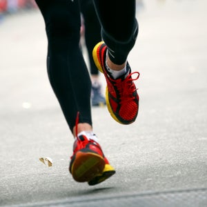 Marathon runner on finish line - legs closeup.