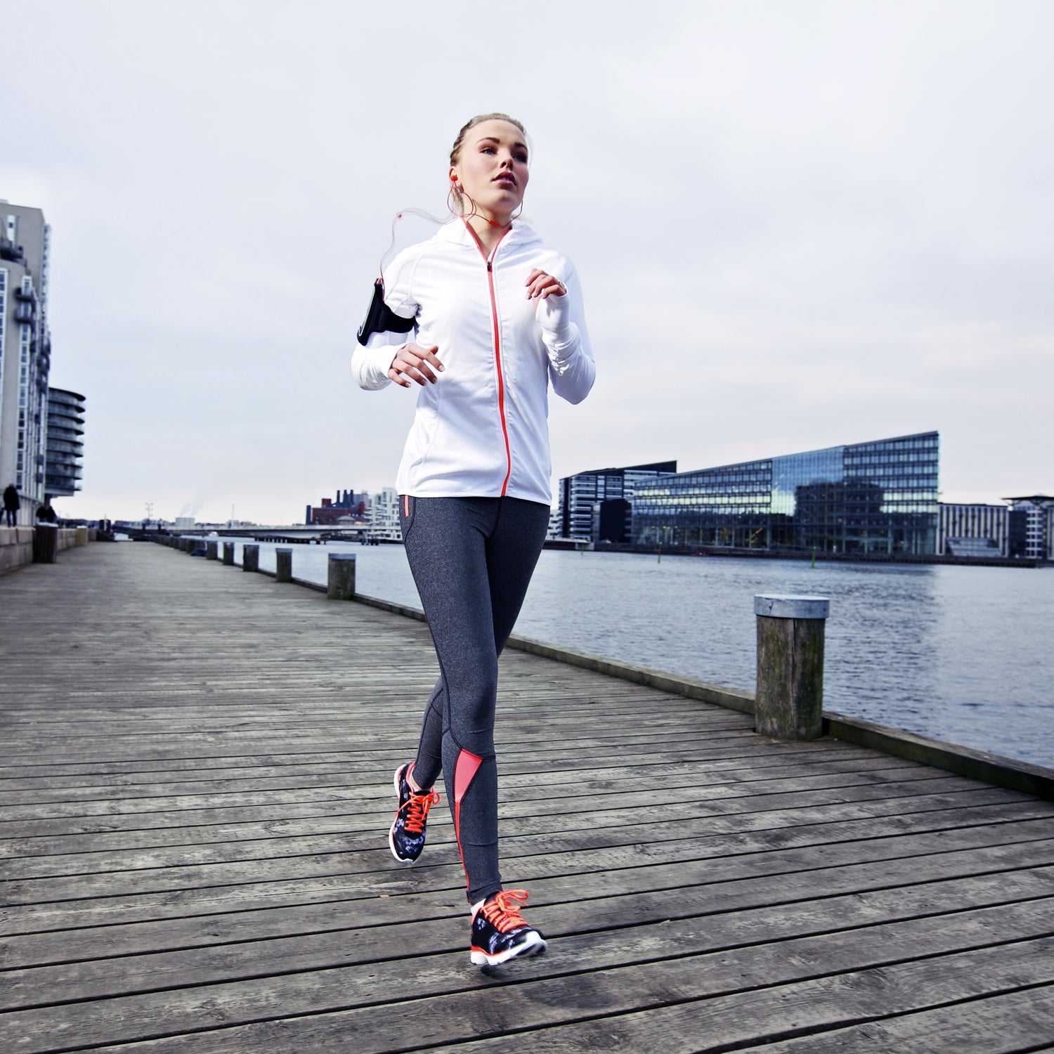 Tall athletic fitness model running in a suburban area showing