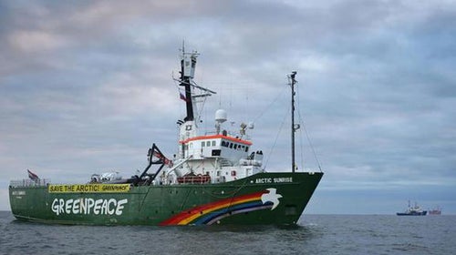 The Greenpeace ship approaching the Arctic Sea oil rig.