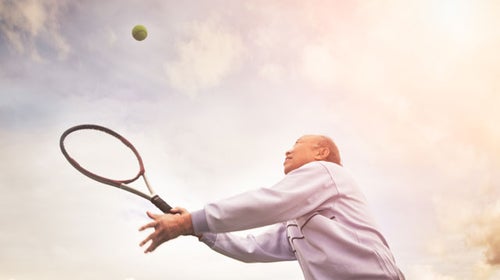 An older athlete hitting the ball.