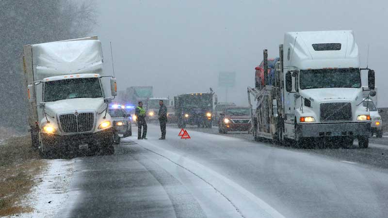 Rockdale County police officers assist a stranded tractor trailer truck on I-20 West near Conyers, Ga. on Tuesday, Jan. 28, 2014.