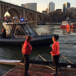 Lena Wang (left) on the Potomac Boat Club dock this morning. Key Bridge and Harbor police circle in the background.