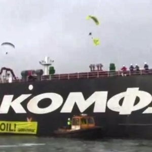 Greenpeace paragliders descend upon the Gazprom oil tanker Mikhael Ulyanov, named for a popular Russian actor.