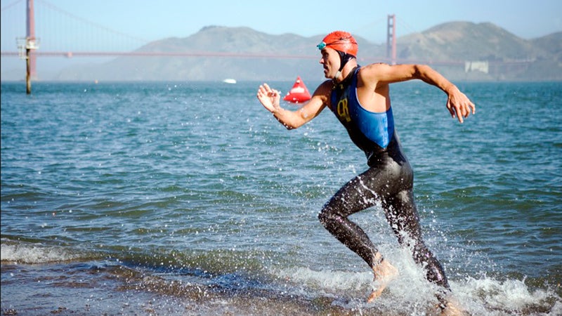 A triathlete finishes the 1.5-mile swim from Alcatraz Island to San Francisco's shore.