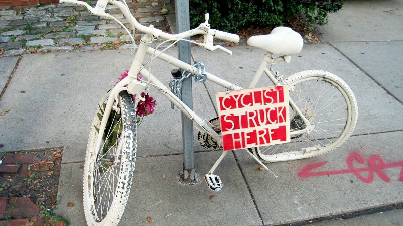 A ghost bike in Pittsburgh, Pennsylvania. Ghost bikes, painted white and placed at scenes of cycling accidents, serve as memorials for cyclists hit or killed on the street.