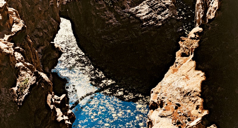 The entrance to Bushman's Hole doesn't hint at the vastness beneath—it's the third-deepest freshwater cave in the world.