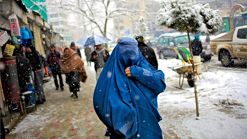 ϳԹ May magazine 2014 Kabul Afghanistan woman walk snow covered