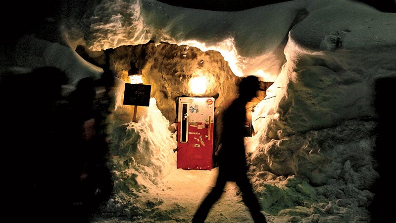 Gyu + bar in Niseko Hirafu area. The entrance of the bar is a small refrigerator. People have to lean front to enter the bar. The bar is packed by foreign tourists.