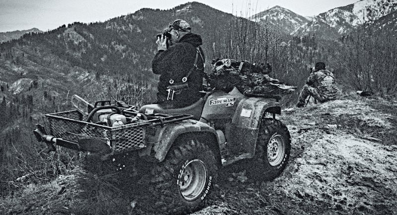 Wolf hunting guide Elijah Coley, left, scans terrain atop Granite Basin with Zeb Redden, right, during a wolf hunt in the Boise National Forest.