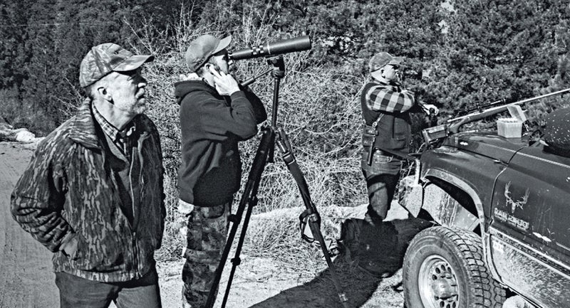 Tom Carter, left, T.J. Carter, center, and Elijah Coley, right, zeroing rifles in the Boise National Forest during a wolf hunt.