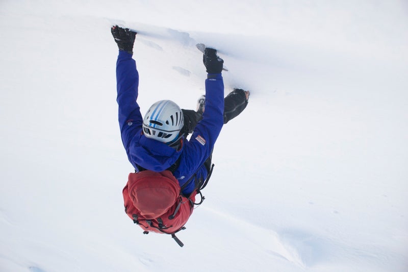 A climber attacks the stark white walls of Scotland's Cairngorms range.