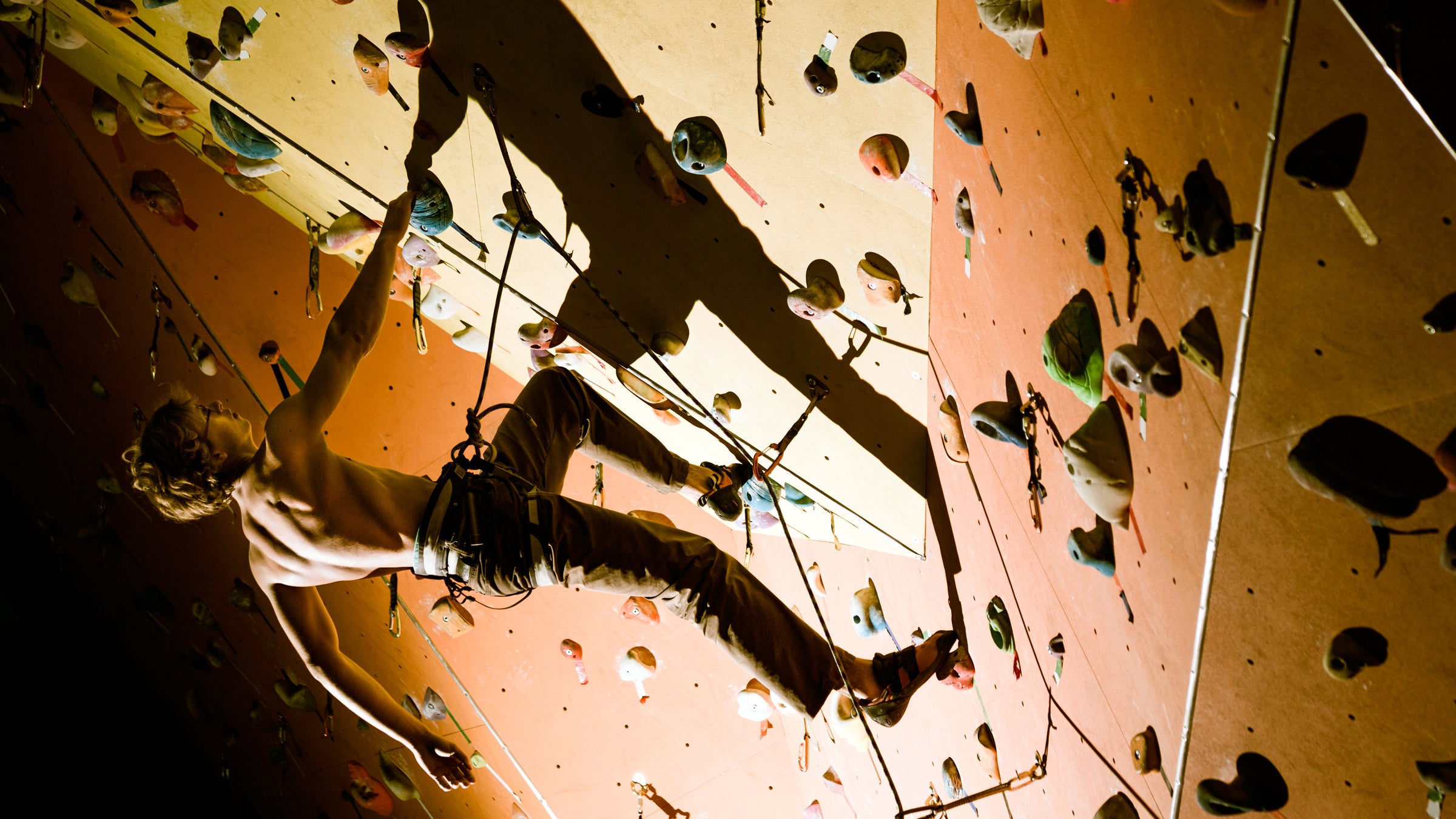 sports rocks teenagers female wall climbing women rope clambering equipment muscular girls reaching exercising strength indoors person one harness athlete health moving club adolescence safety gym mountain action effort woman extreme exercise stretching hanging recreational courage balance caucasian beautiful leisure men portrait male lifestyles rock people vertical looking healthy rough man handsome masculinity standing face serious torso dark shadow