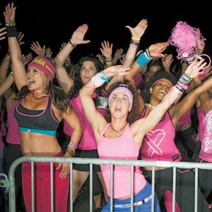20-29 Years Anticipation Carefree Caucasian Ethnicity Cheerful Convention Center Dancing Enjoyment Exhilaration Femininity Fitness Front View Gesturing Hand Raised Happiness Indoors Leisure Lifestyles Medium  Group Of People Pink Pom Pom Portrait Railing Smiling Spectator Standing Tank Top Text Three Quarter Length Togetherness Vitality Waving Weekend Activities Western Script Woman Young Woman Youth Culture Zumba