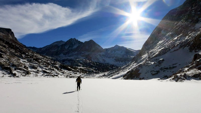 Lichter skis over the frozen Lower Palisade Lake.