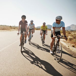 action active activity adult athlete athleticism bicycle caucasian challenge competitive sport copyspace cropped cycle cyclist determination endurance enjoyment exercise exercising female fit fitness focus goal group happiness happy health healthy horizontal lifestyle looking male man men outdoors outside people physical activity race racing bicycle riding road smile smiling sport sportswear tenacity training triathlon two people wellbeing wellness woman young young man young woman